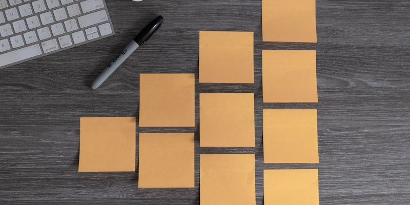 yellow sticky notes beside white apple magic mouse and white apple keyboard