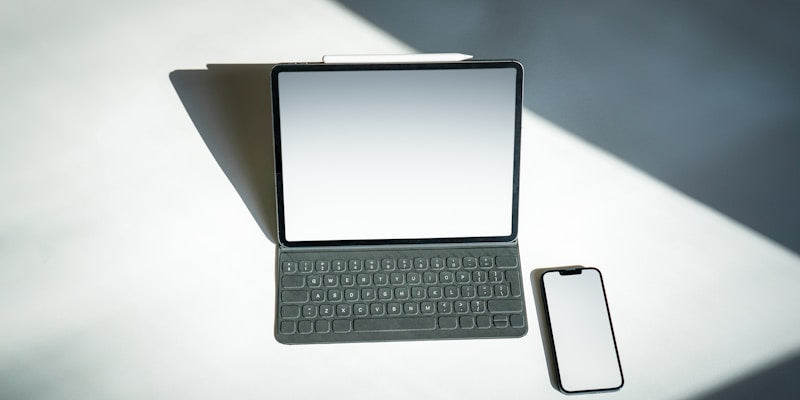 a tablet and a cell phone sitting on a table